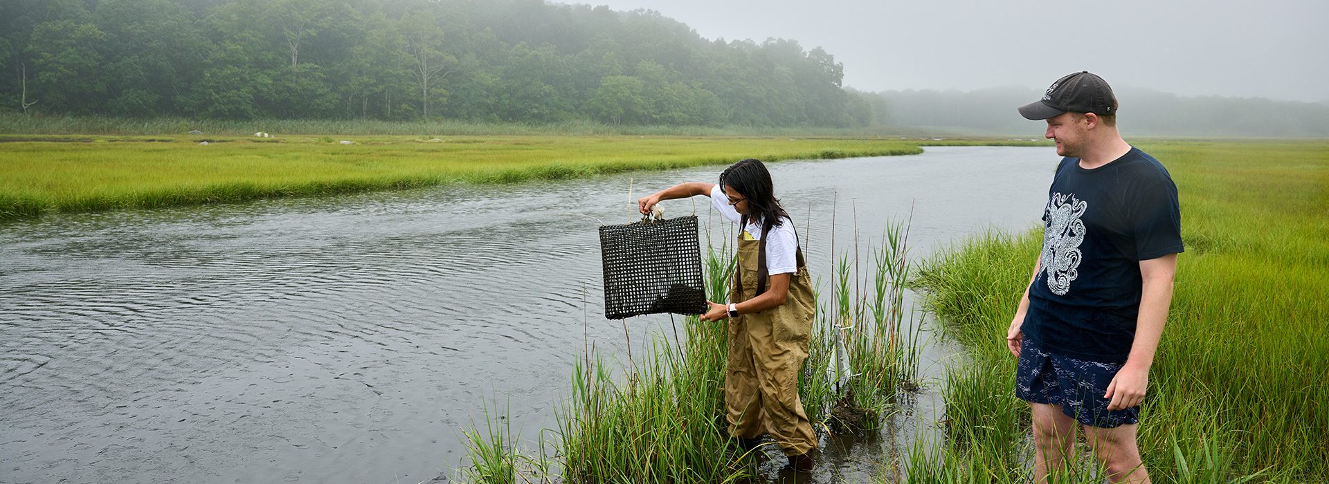 Two marine science researchers take samples at the Barn Island Wildlife Management Area